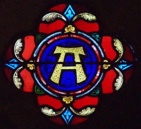 One of two tiny roundels over the altar of All Saints' church, this is the sign for 'alpha', as in 'I am the alpha and the omega', i.e. the beginning and the end.